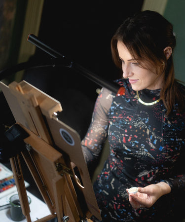 Irish artist painting at easel 